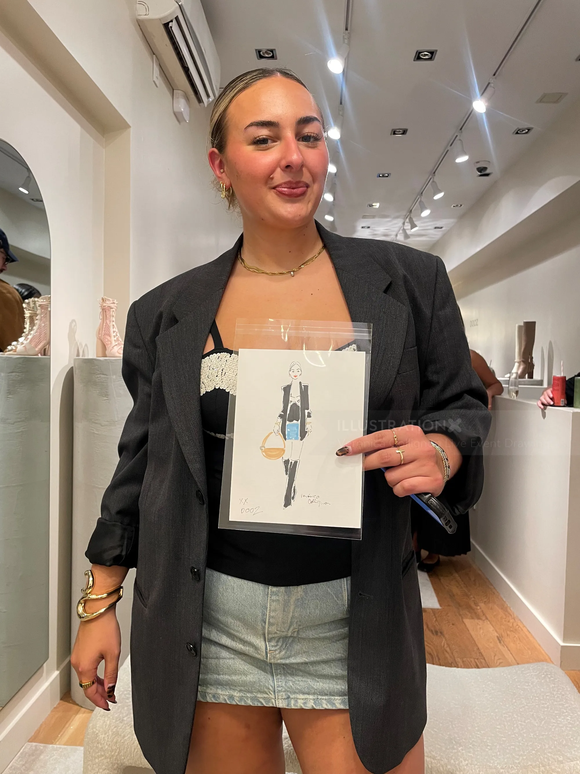 Woman holding fashion drawing inside contemporary art gallery