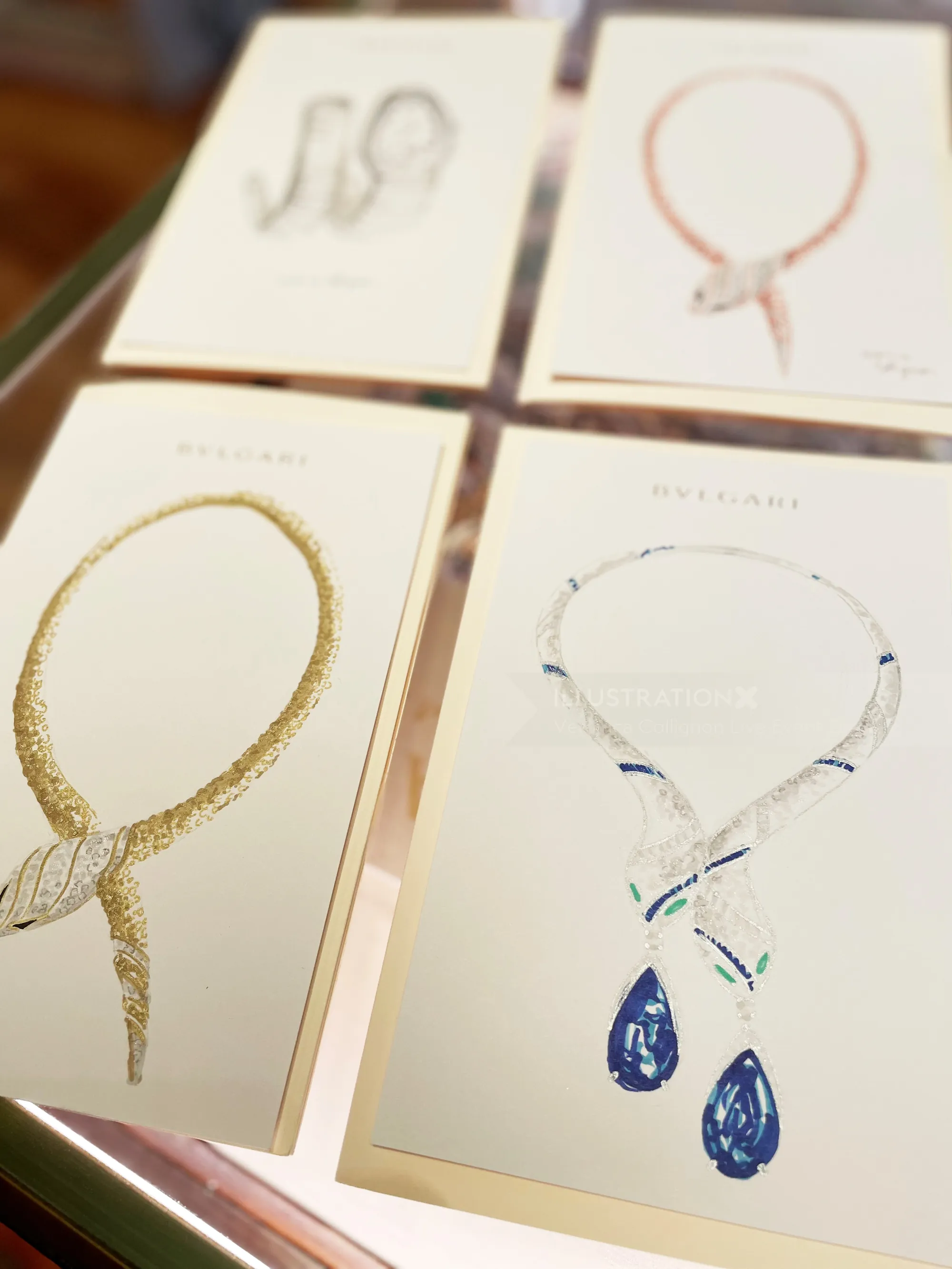 Drawings of various elegant necklaces with gemstones on display cards