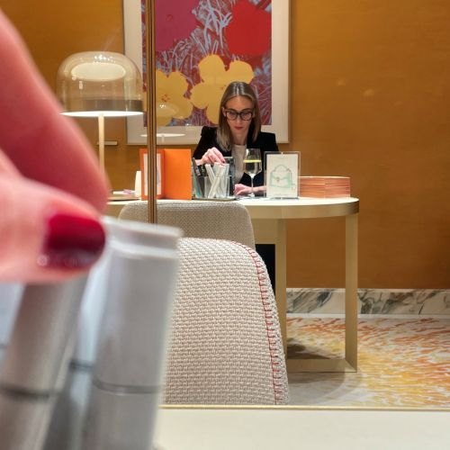 Person sitting at desk with laptop and abstract colorful wall art