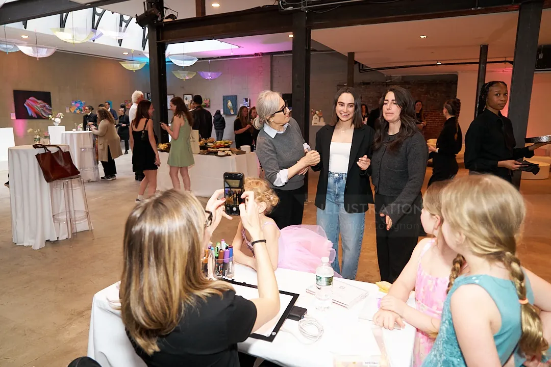 Group of people at an indoor social event with photography and mingling