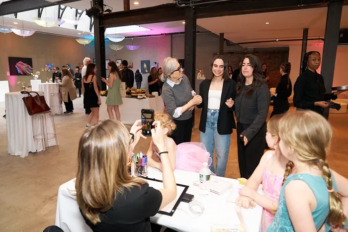 Group of people at an indoor social event with photography and mingling