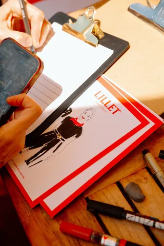 Hand drawing on paper with Lillet art print and markers on table