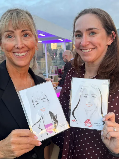 Veronica Collignon Live Event Drawing artist with a woman holding portrait sketches