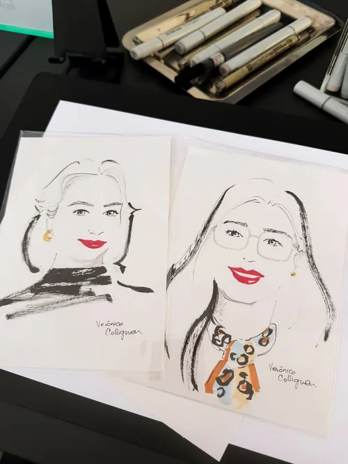 Veronica Collignon sketches two fashion portraits on paper beside drawing markers.