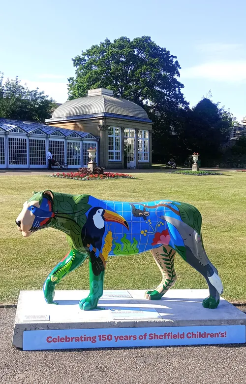 Vicky Scott's colorful lion sculpture displayed on a lawn