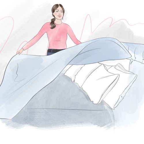 Lifestyle woman making bed