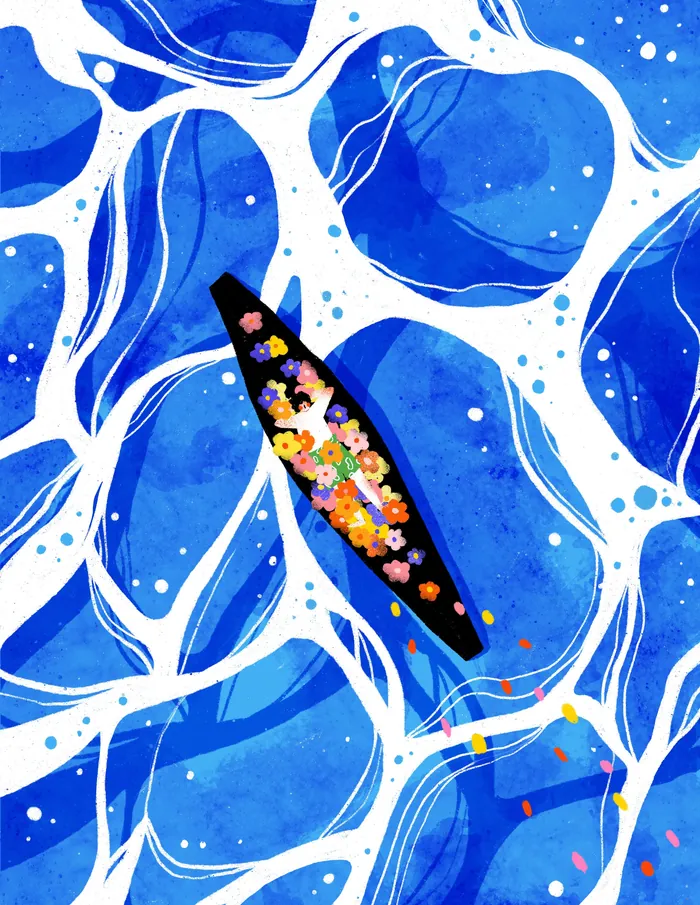 Boat filled with colorful flowers floating on blue ocean waves