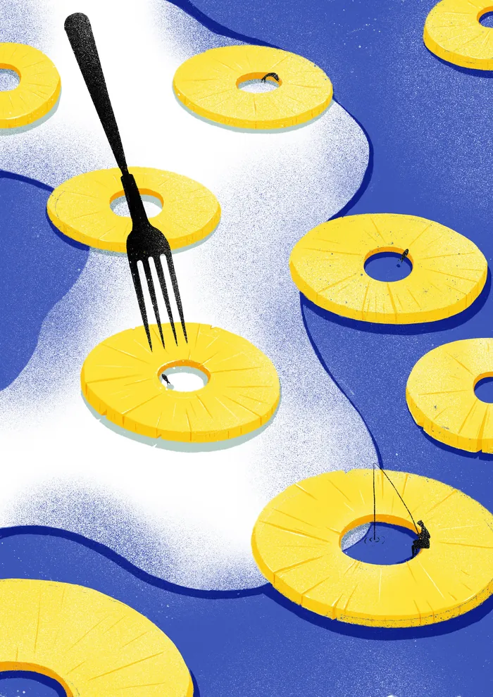 Yellow pineapple rings floating on blue and white surface with a black fork