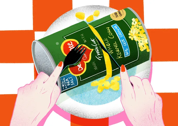 Hands opening a can of sweet corn on a plate with a fork