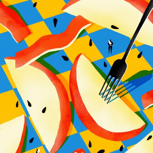 Fork with apple slices on colorful checkered tablecloth