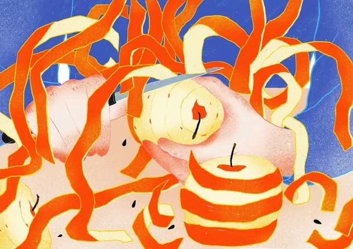 An apple being peeled with long orange peel ribbons around it