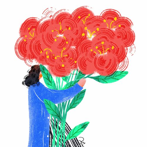 Person in blue coat carrying large bouquet of red flowers