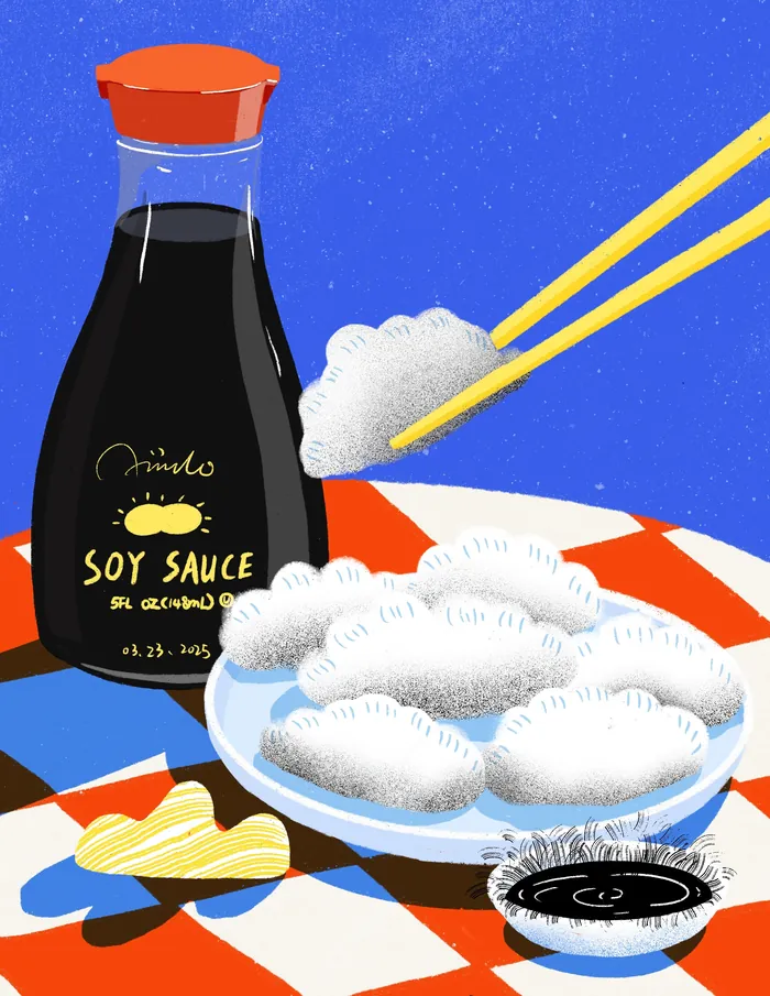 Plate of dumplings with soy sauce and chopsticks holding one dumpling