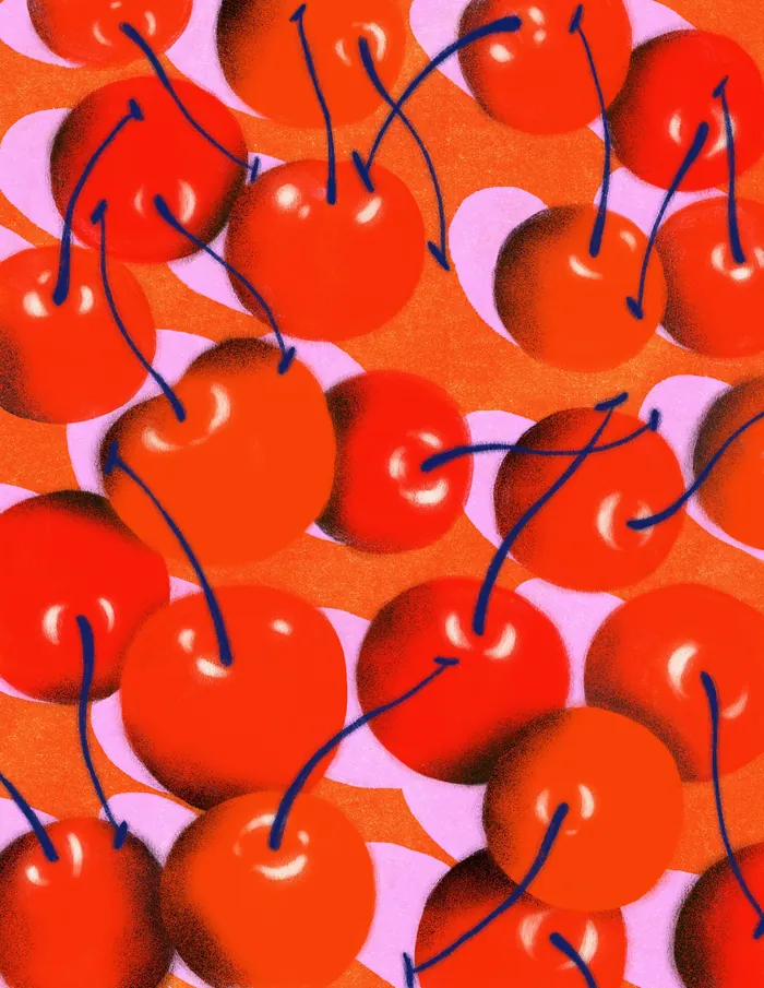 Bright red cherries with stems on a pink and orange background