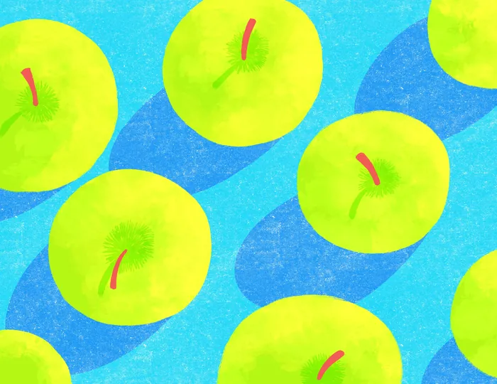 Bright green apples on a vibrant blue background