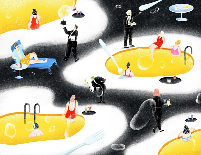People relaxing in yellow pools with waiters serving drinks