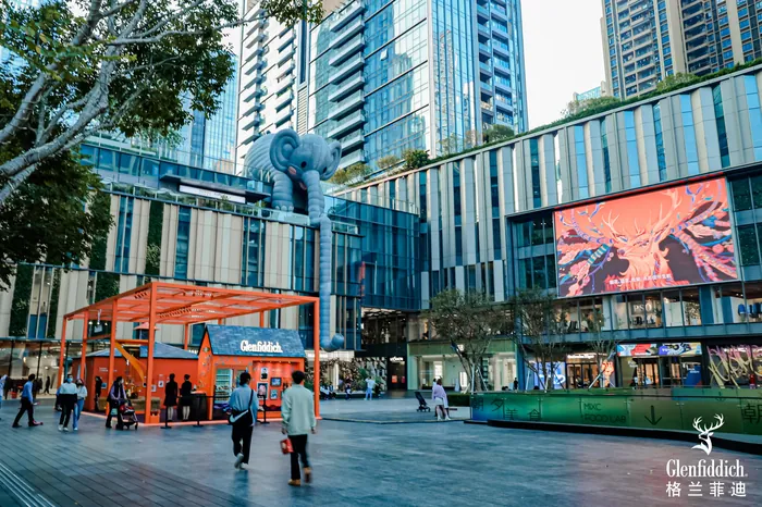 Urban plaza with digital billboard and people outdoors by Yixin Zeng