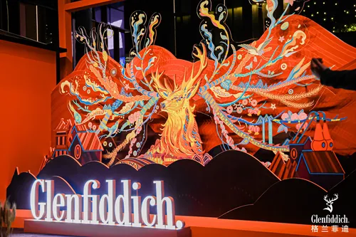 Illuminated Glenfiddich display with bright fiery deer artwork by Yixin Zeng
