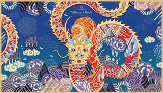Colorful Asian dragon winding through a stylized blue landscape