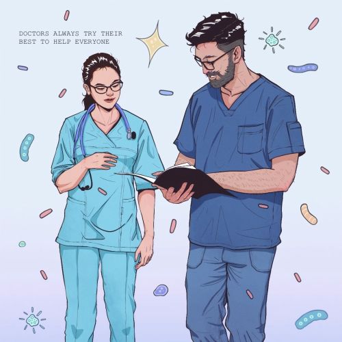 Two doctors in scrubs reading medical notes by Yogi Fahmi Riandito