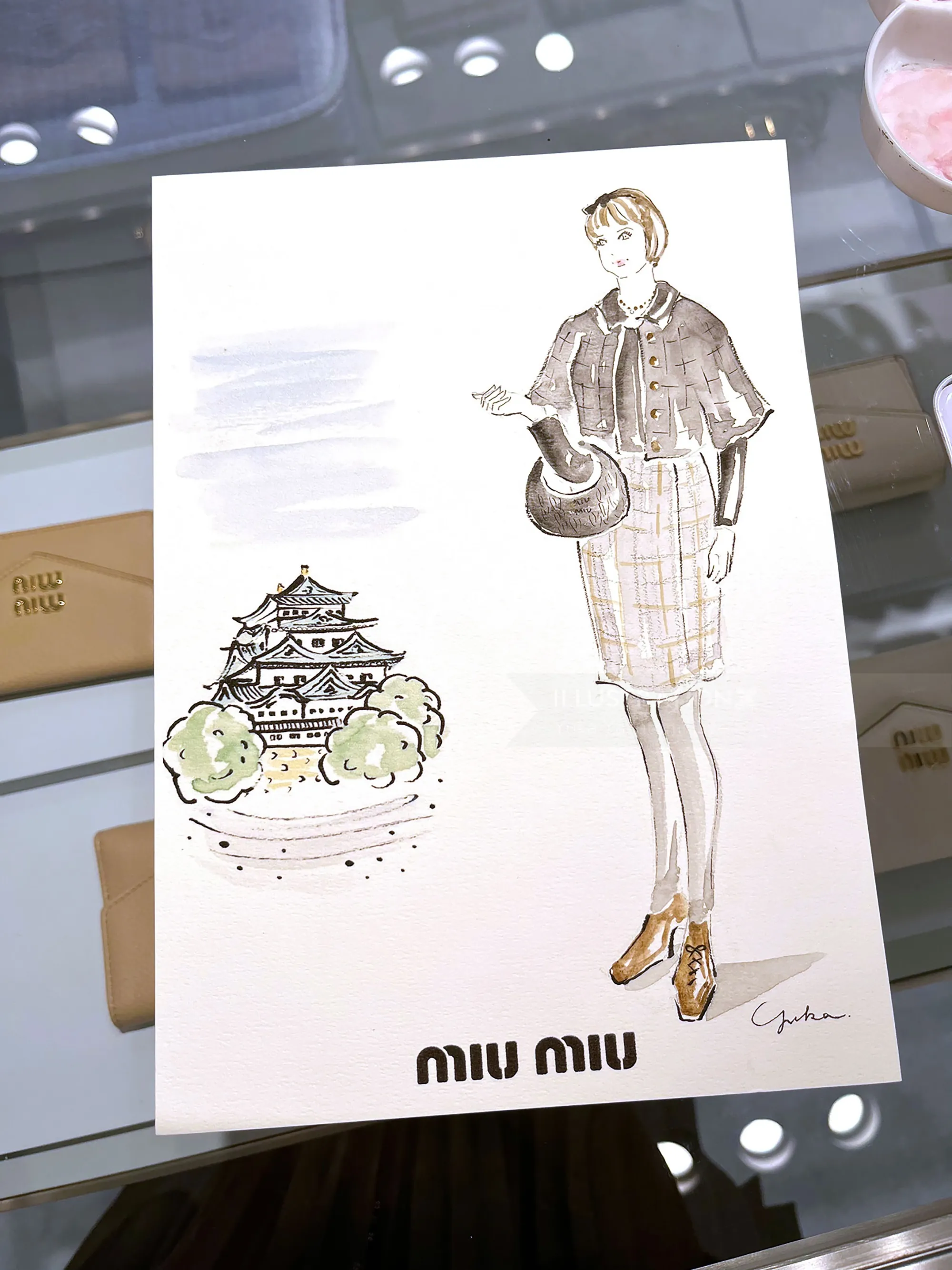 Fashion illustration of woman in cape with castle sketch