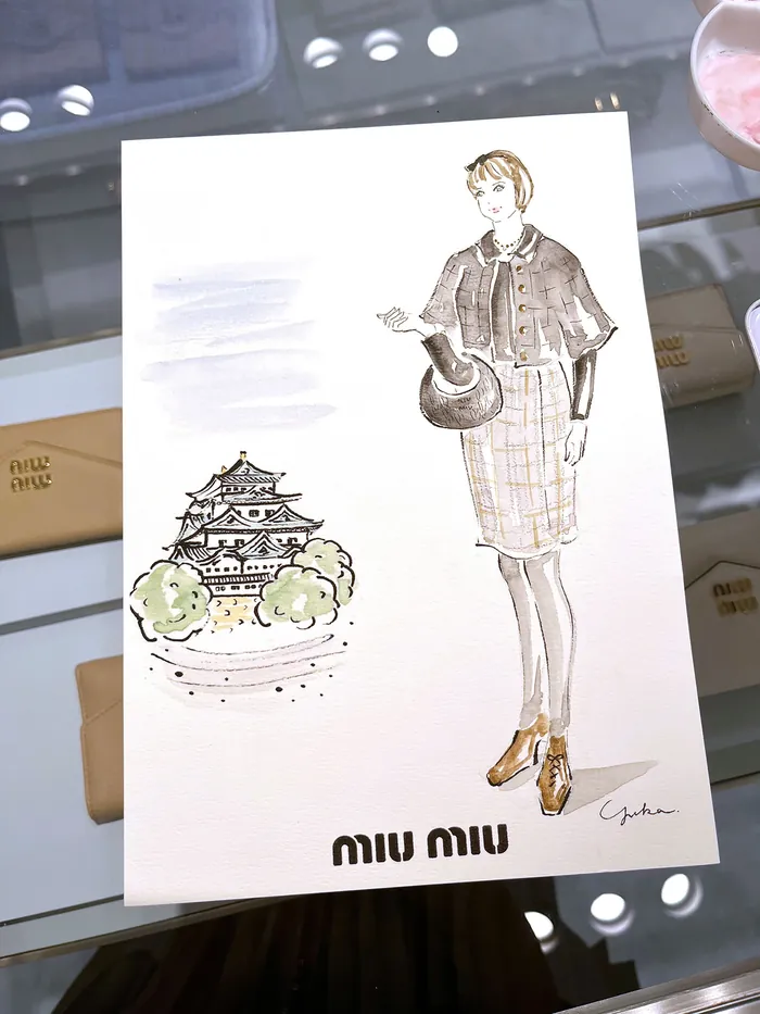 Fashion illustration of woman in cape with castle sketch