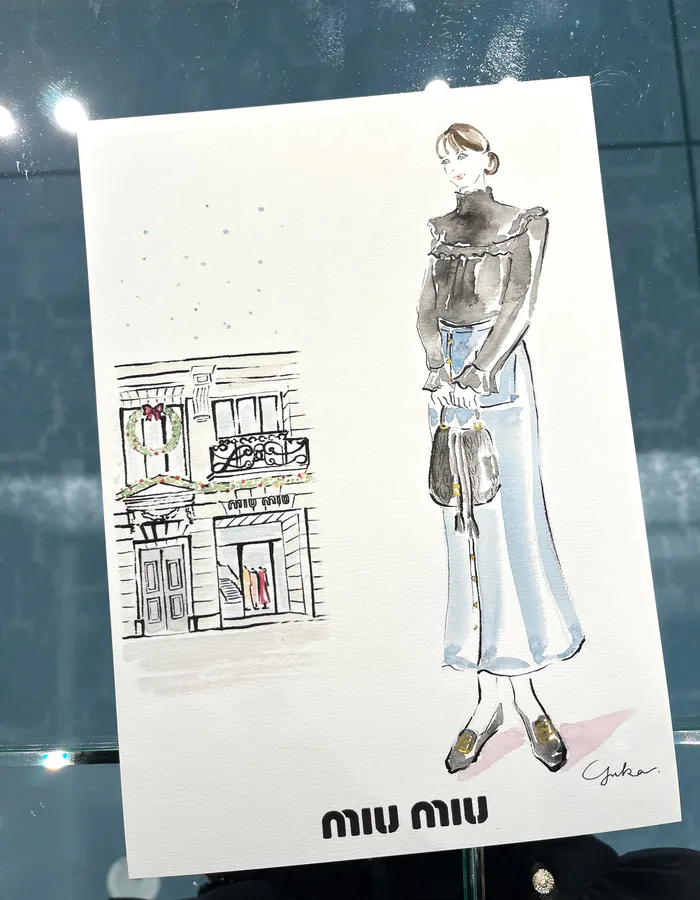 Fashion sketch of woman in long skirt holding handbag