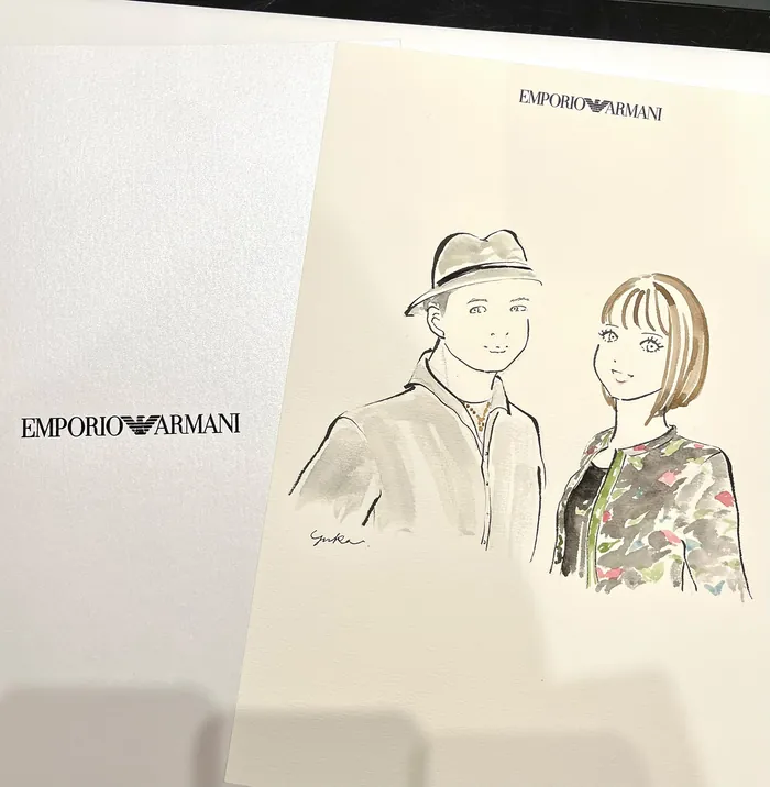 Sketch of a man and woman at an Emporio Armani event