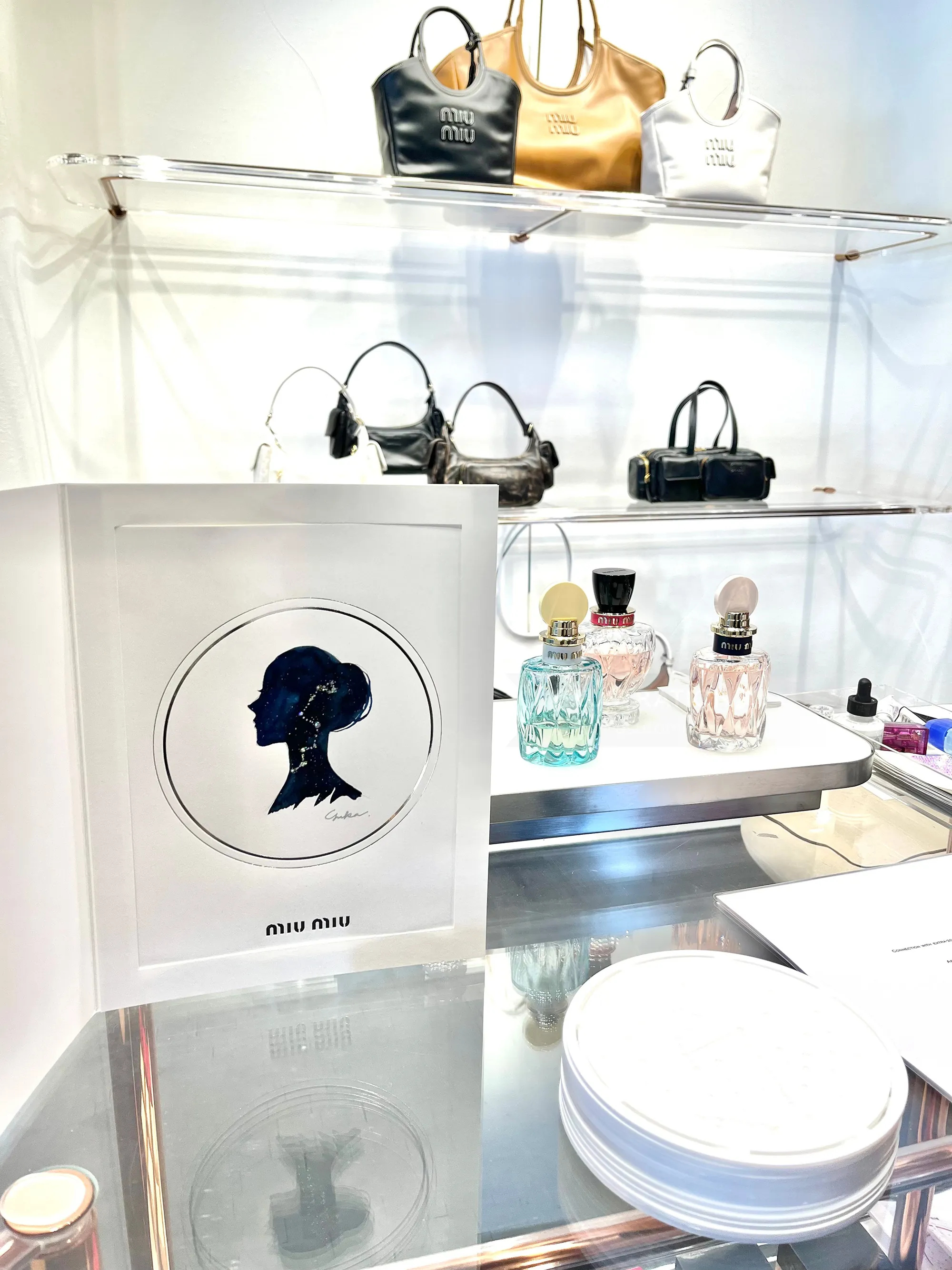 MIU MIU event display with handbags and perfume bottles
