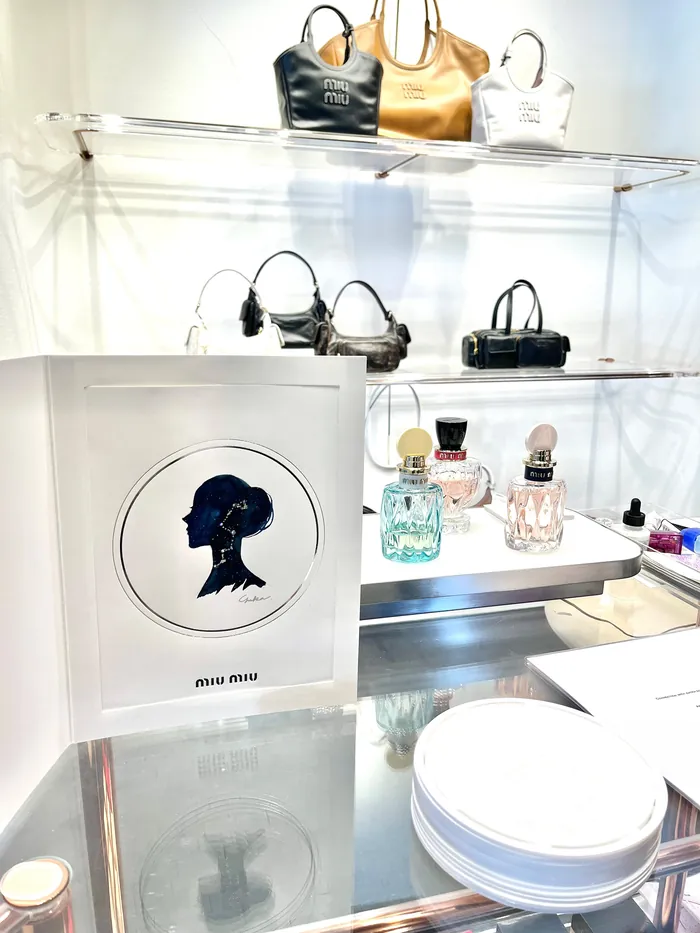 MIU MIU event display with handbags and perfume bottles
