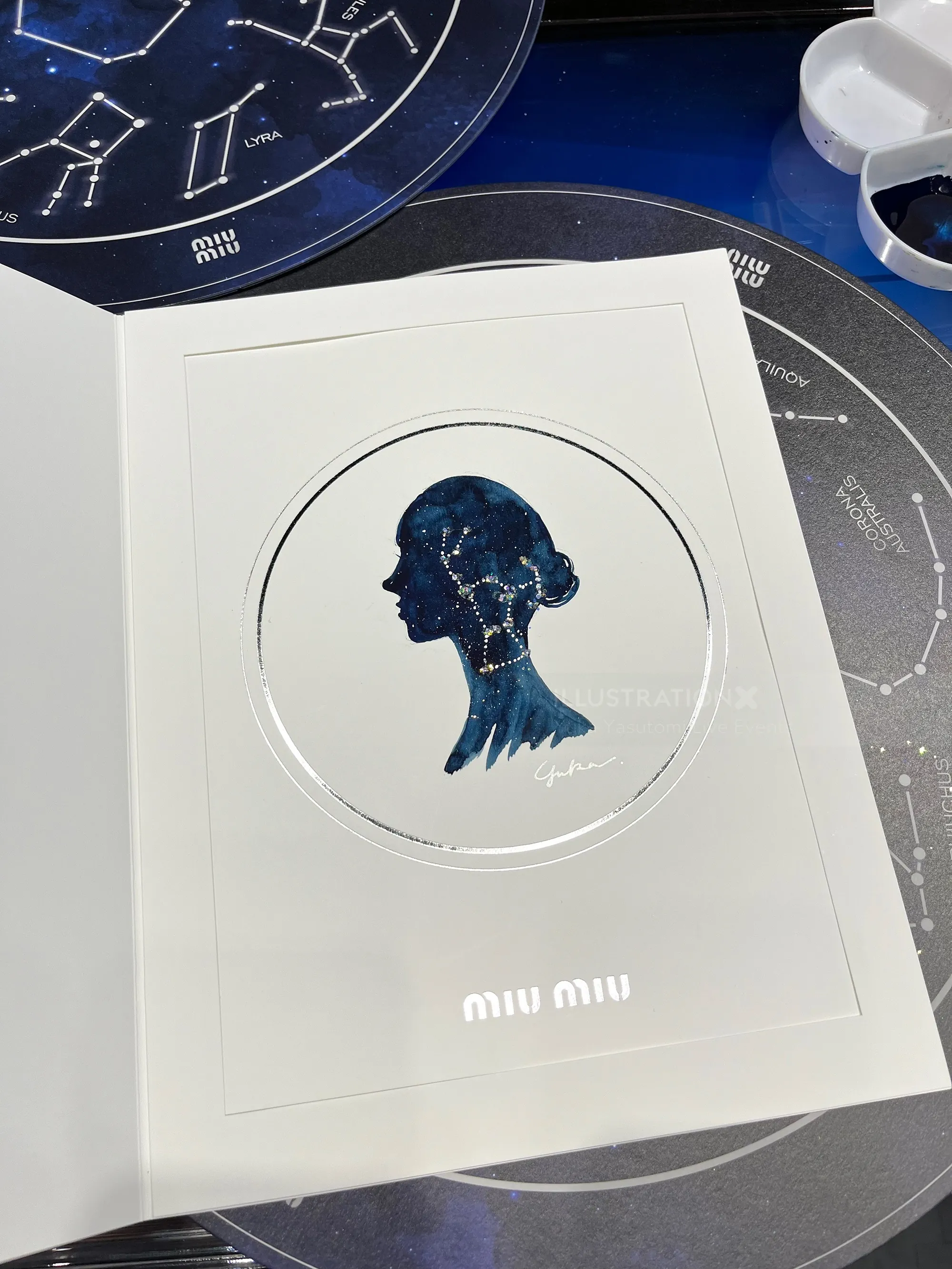 Miu Miu event card with silhouette art and constellation background