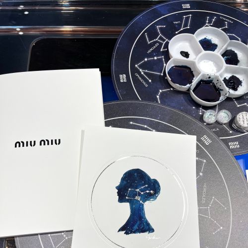 MIU MIU event cards with blue silhouette and constellation backdrop