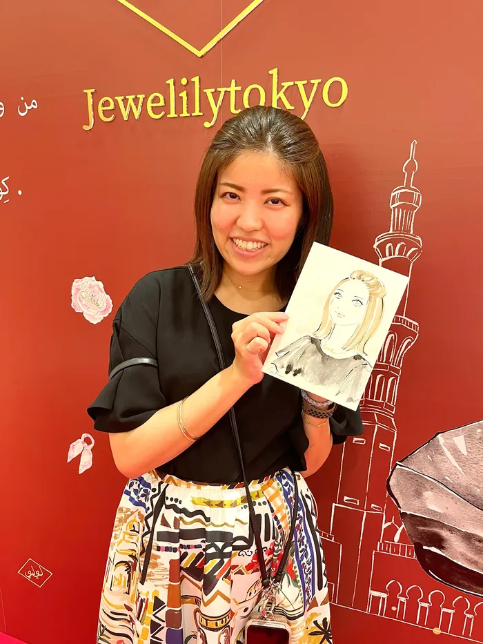 Woman holding a portrait sketch at Jewelilytokyo live event