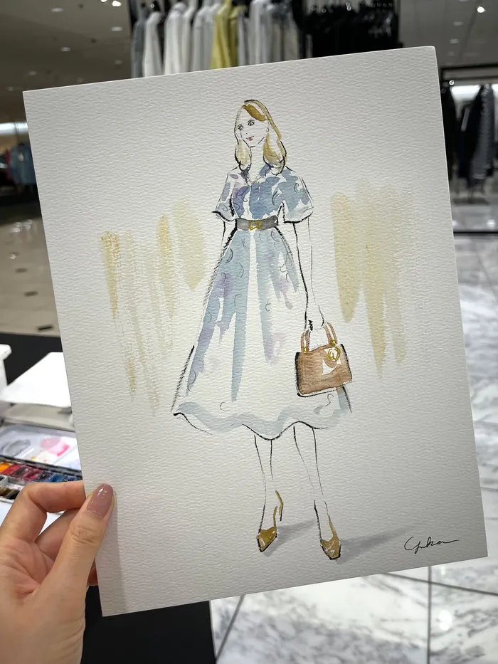 Watercolor fashion illustration of woman in blue dress with handbag