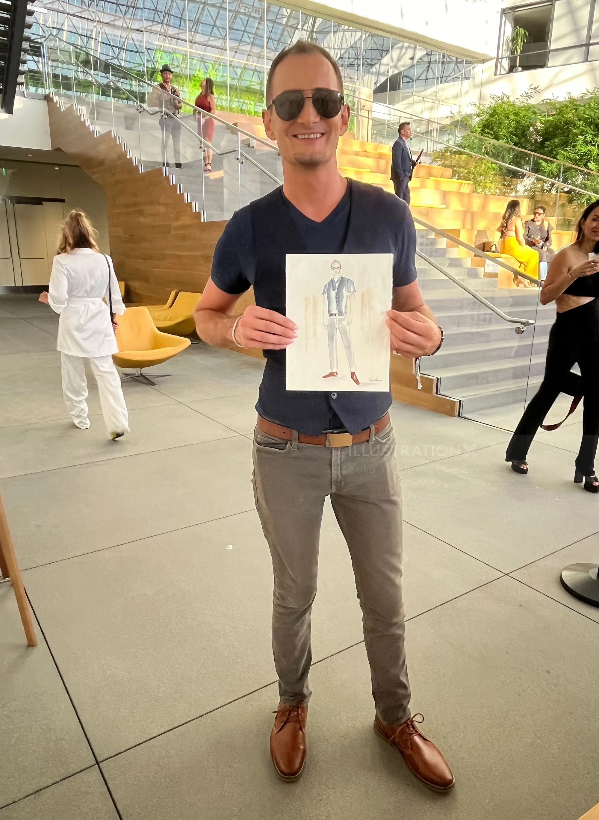 Man holding fashion sketch at outdoor LA Fashion Week event