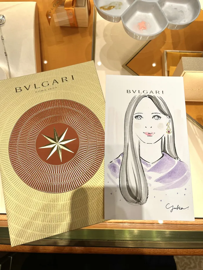 Bulgari event card and illustrated portrait on display