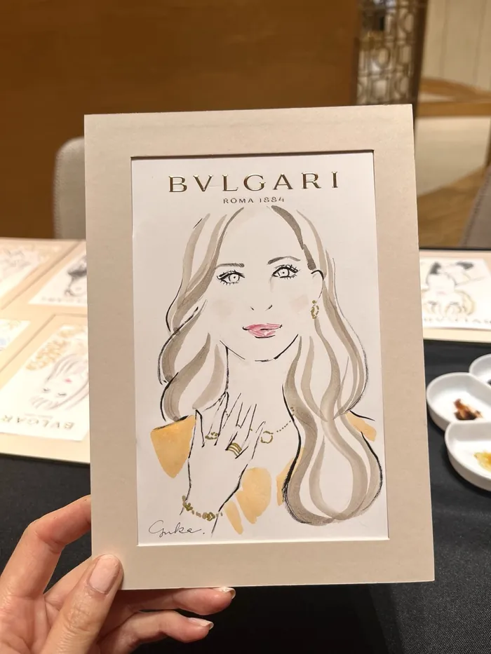 Drawing of woman with Bvlgari rings and earrings
