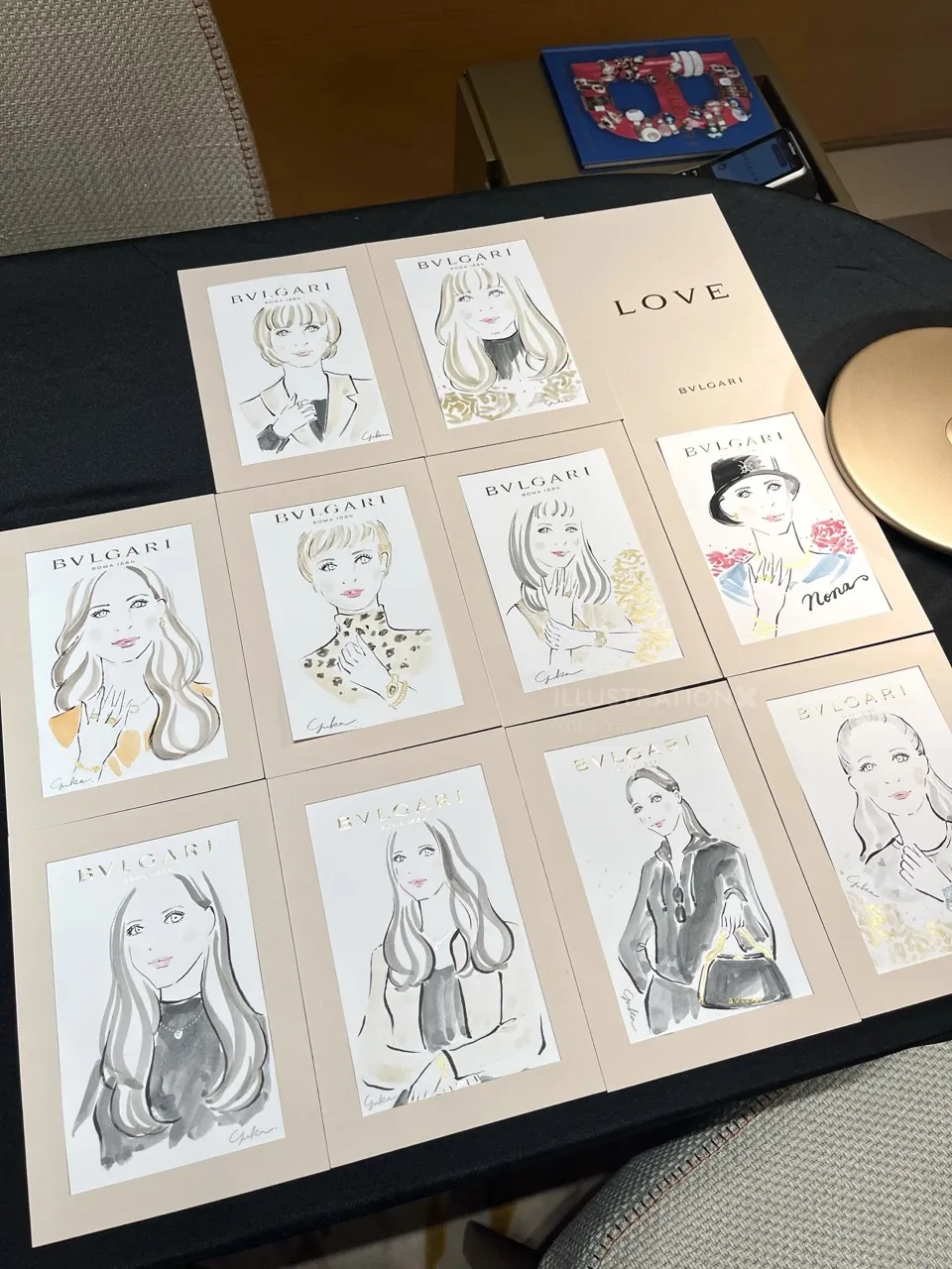 Illustrated portraits displayed on table at Bulgari event
