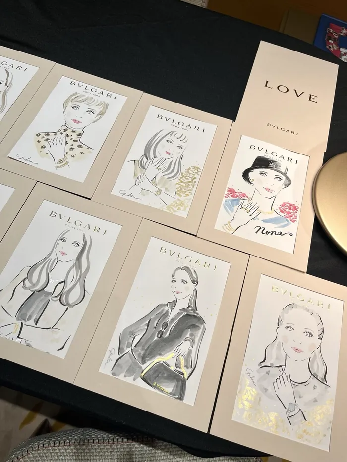 Illustrated portraits of women displayed at a Bulgari live event