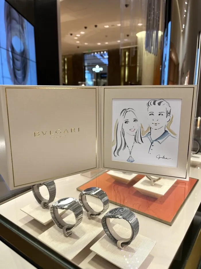 Bulgari watches displayed with framed illustration in luxury store