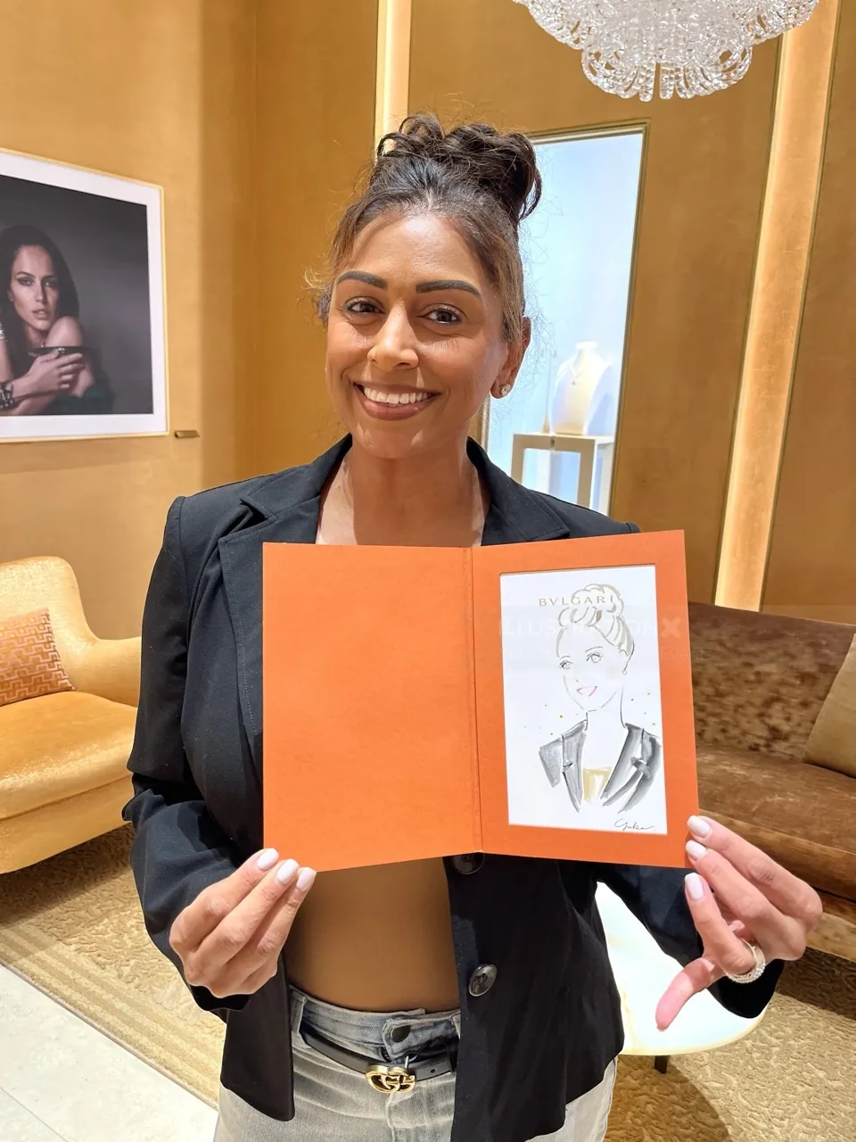 Woman holding a caricature portrait at Bulgari event