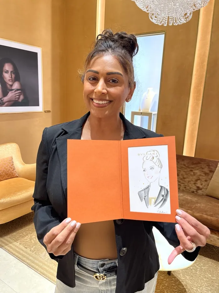 Woman holding a caricature portrait at Bulgari event