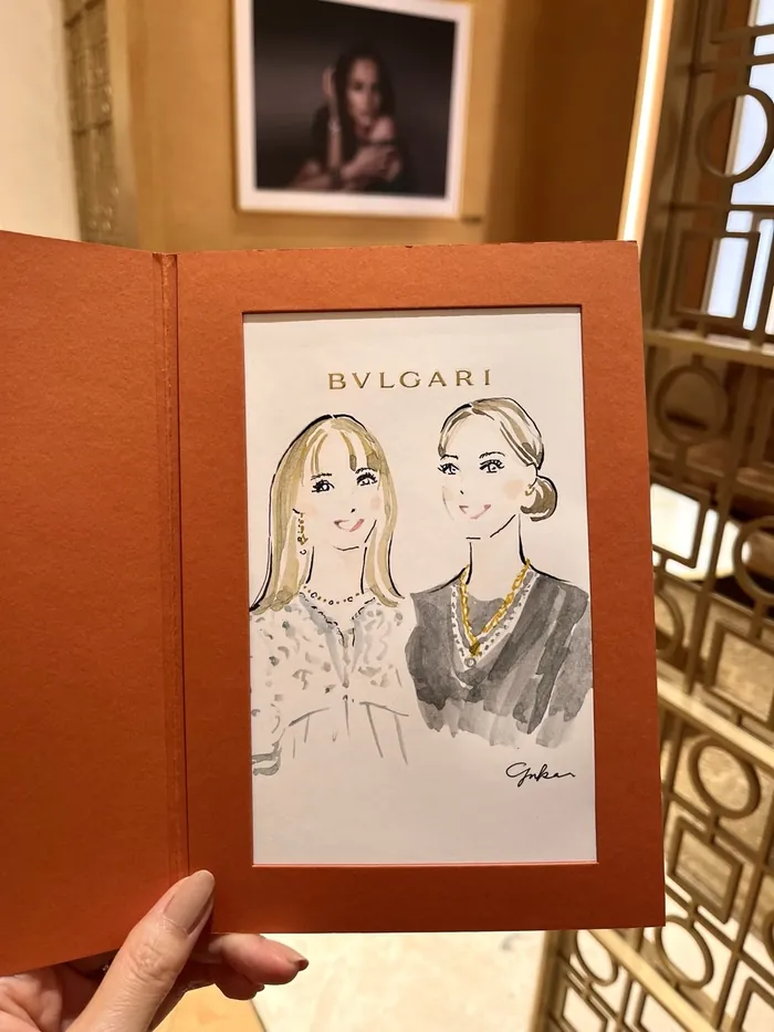 Illustration of two women wearing Bulgari jewelry in a leather folder