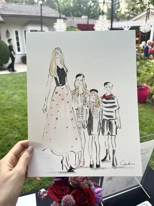Hand holding fashion illustration of four people at outdoor event