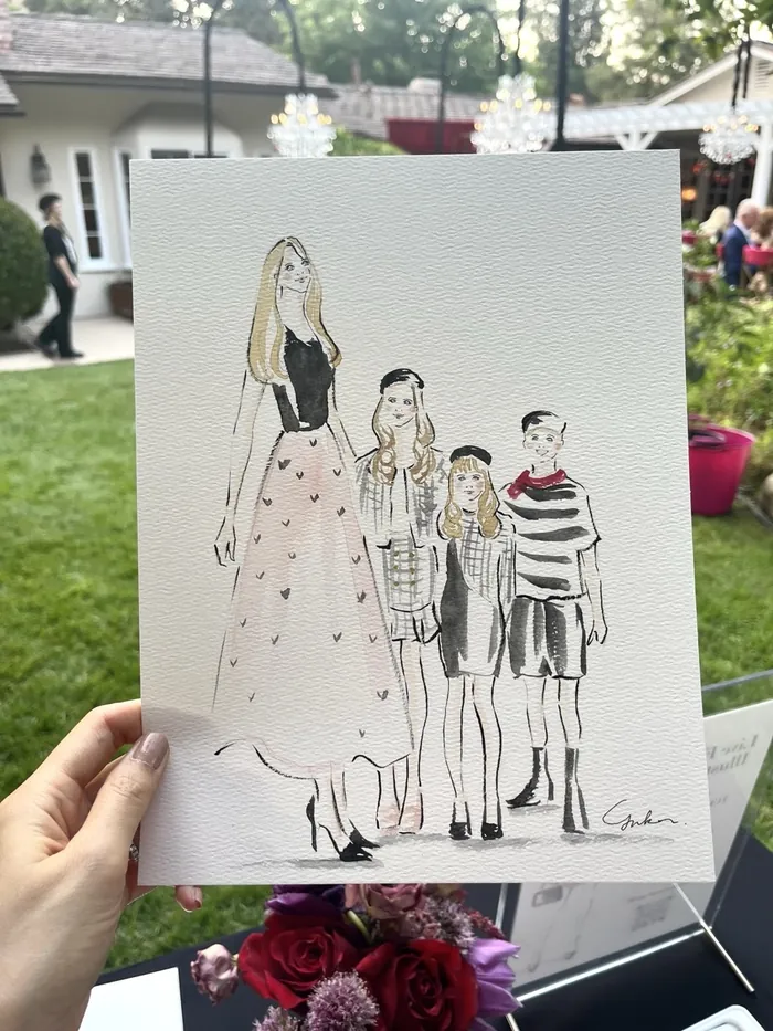 Hand holding fashion illustration of four people at outdoor event