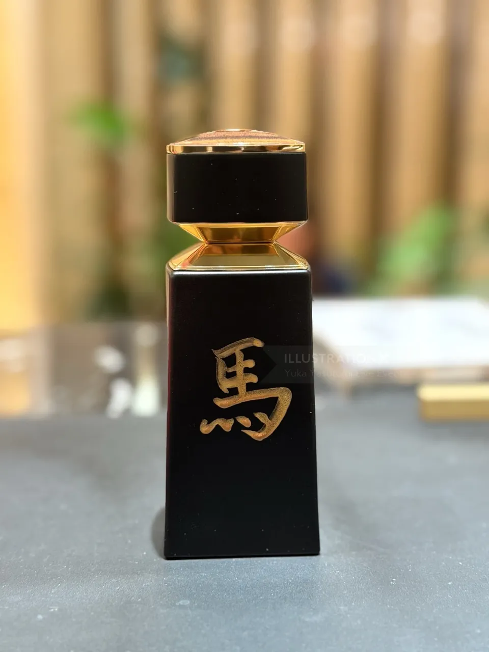 Black bottle with gold calligraphy by Yuka Yasutomi Live Events