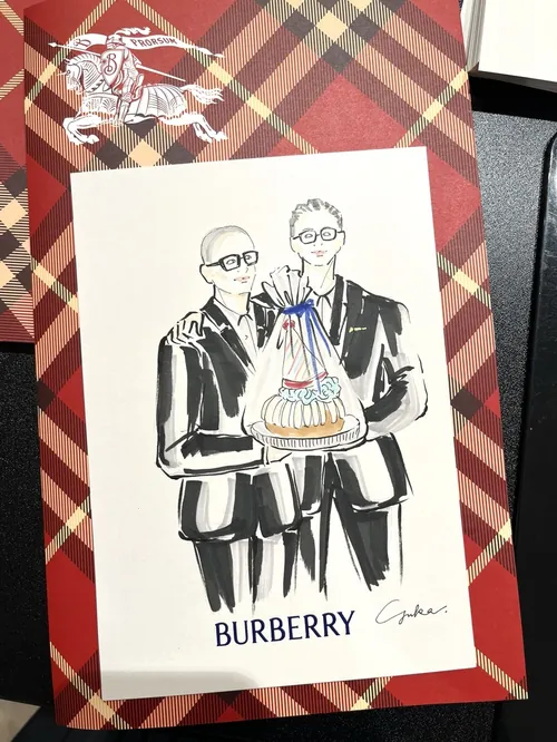 Illustration of two men holding a cake at Burberry event by Yuka Yasutomi