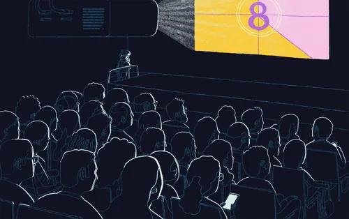 Crowd in dark theater watching colorful movie projection by Zansky