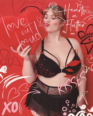 Woman in black lingerie holding heart balloon with drawn hearts by Nadia Flower