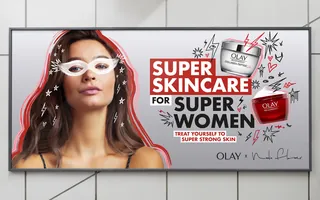 Olay skincare billboard with woman and product jars by Nadia Flower
